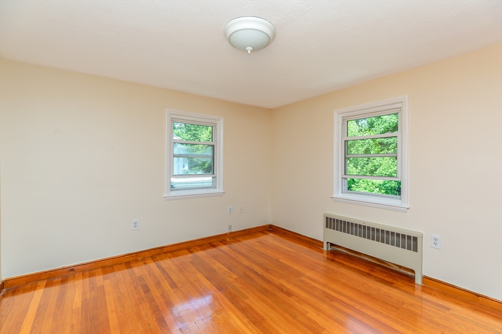 21 Allerton Road Milton, MA 02186 - Photo 18 of 42 a view of an empty room with wooden floor and a window