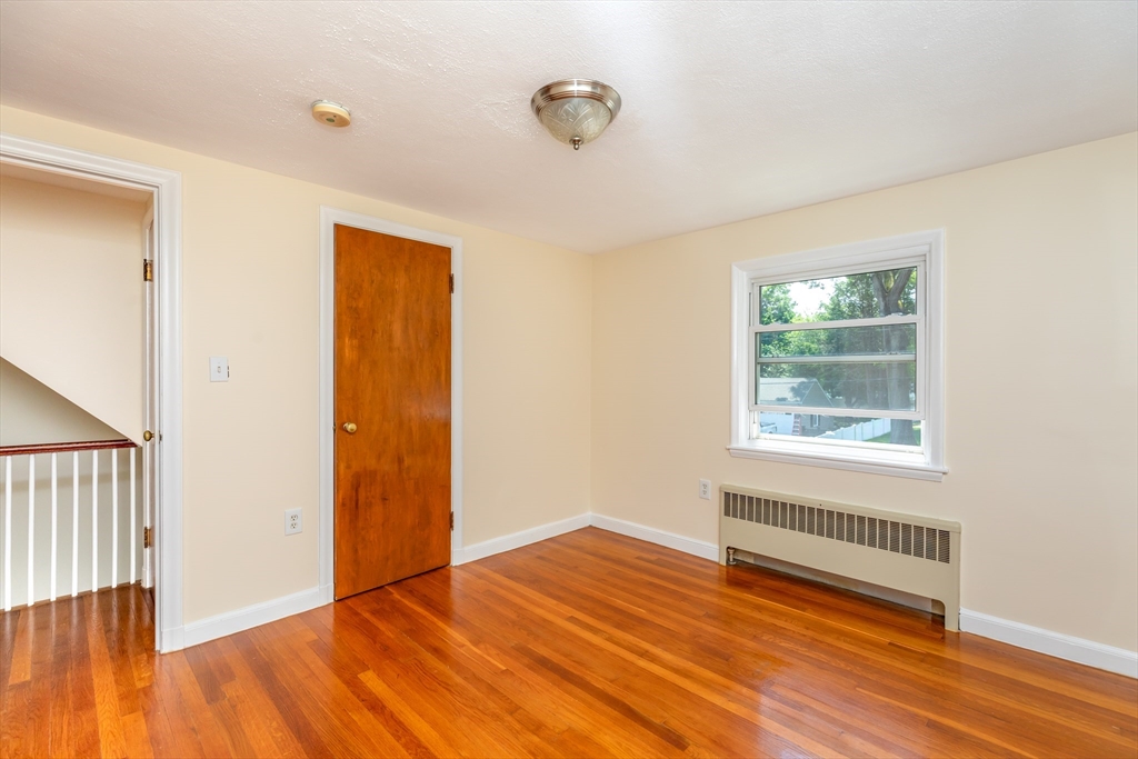 21 Allerton Road Milton, MA 02186 - Photo 19 of 42 a view of an empty room with wooden floor and a window
