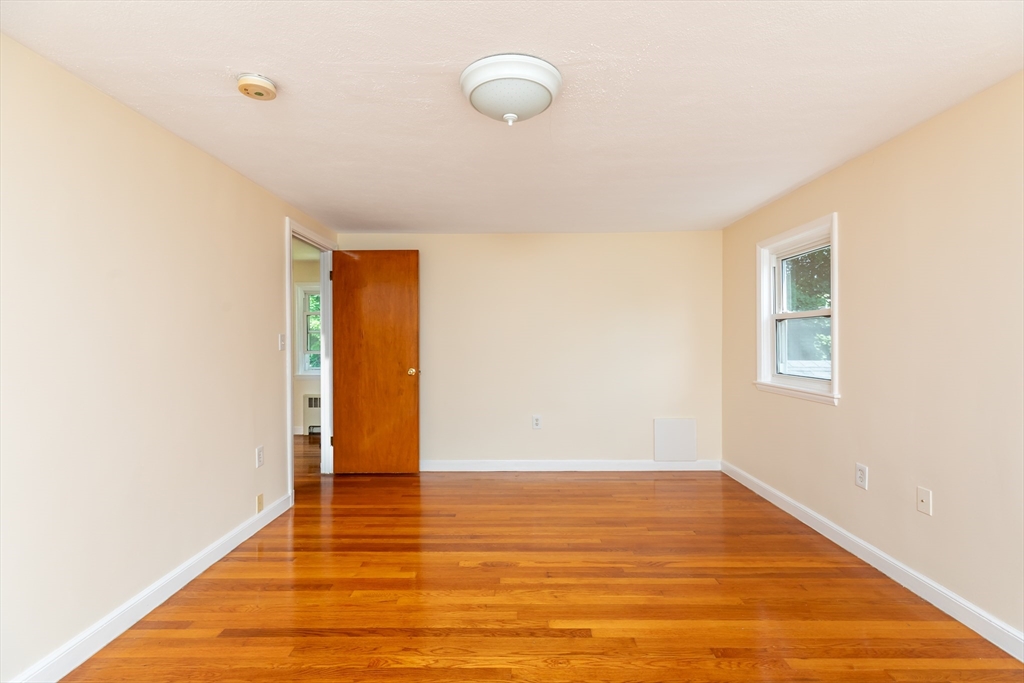 21 Allerton Road Milton, MA 02186 - Photo 21 of 42 a view of an empty room with wooden floor