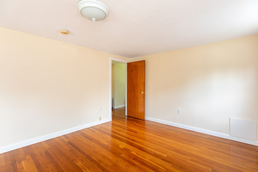 21 Allerton Road Milton, MA 02186 - Photo 23 of 42 a view of an empty room with wooden floor