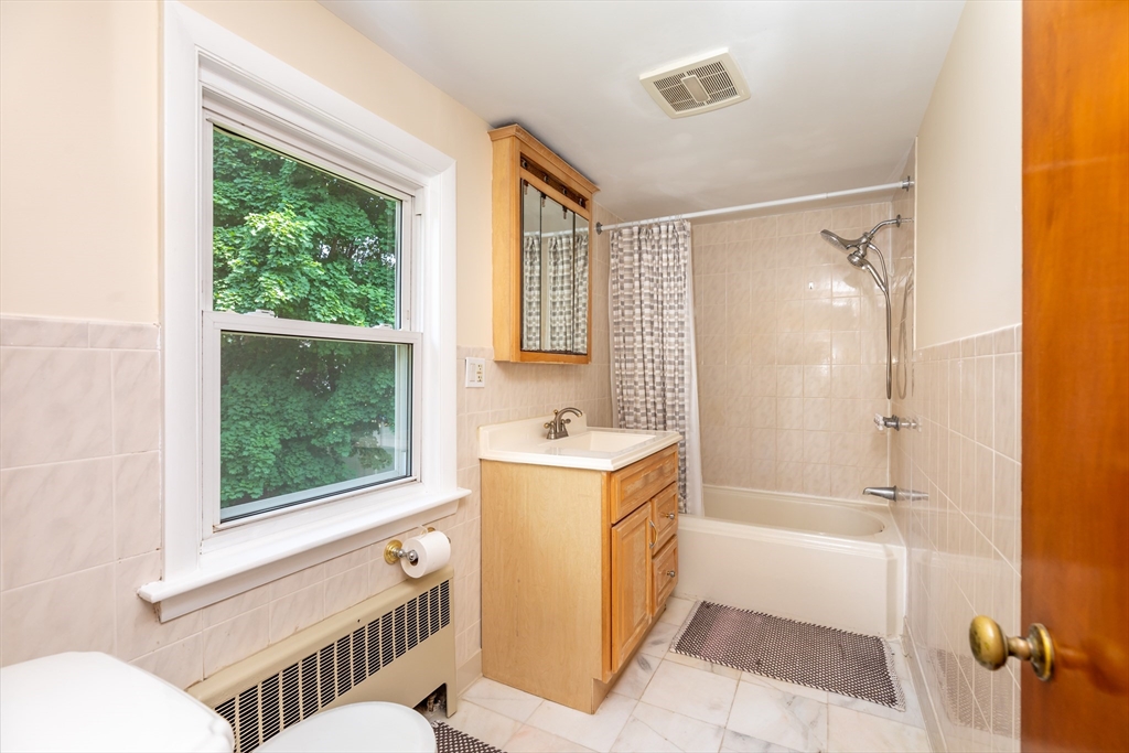 21 Allerton Road Milton, MA 02186 - Photo 25 of 42 a bathroom with a tub sink and mirror