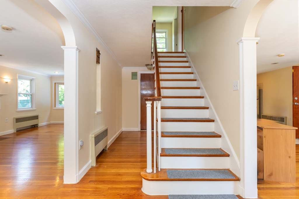 21 Allerton Road Milton, MA 02186 - Photo 3 of 42 a view of a hallway with wooden floor and windows