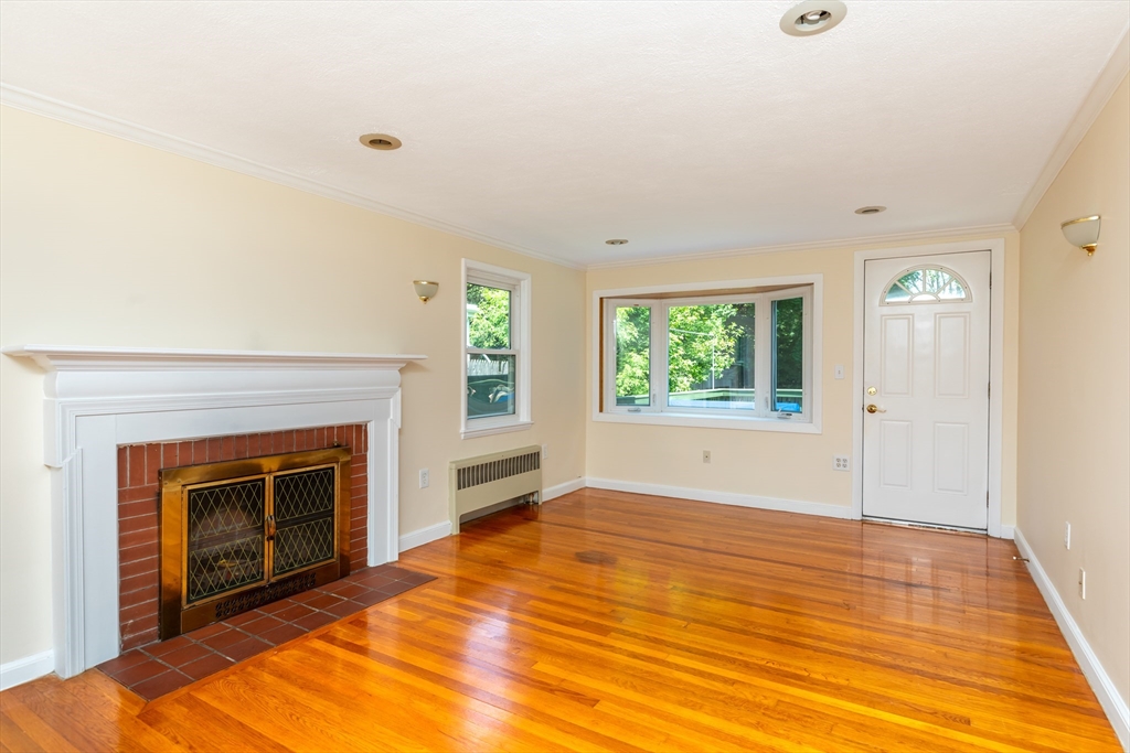 21 Allerton Road Milton, MA 02186 - Photo 5 of 42 an empty room with windows and fireplace