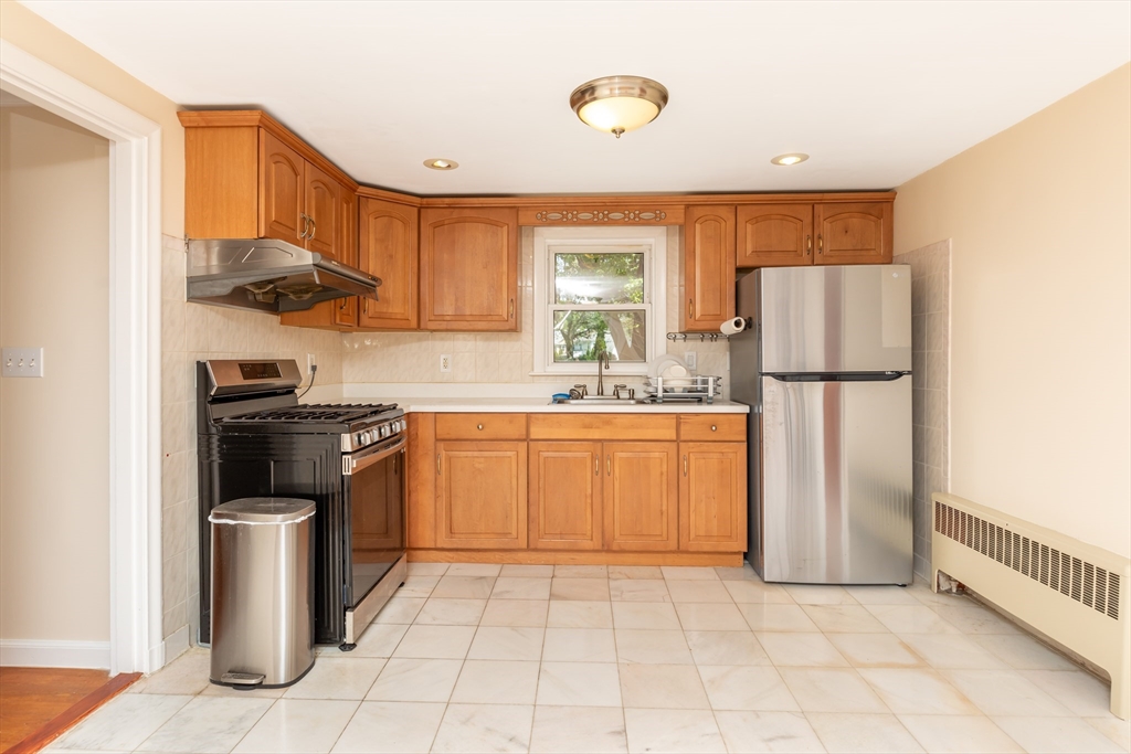 21 Allerton Road Milton, MA 02186 - Photo 9 of 42 a kitchen with a sink a refrigerator and a stove