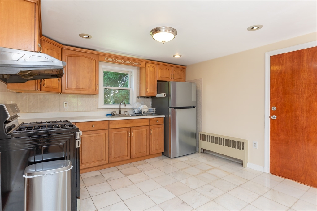 21 Allerton Road Milton, MA 02186 - Photo 10 of 42 a kitchen with a sink a stove and refrigerator
