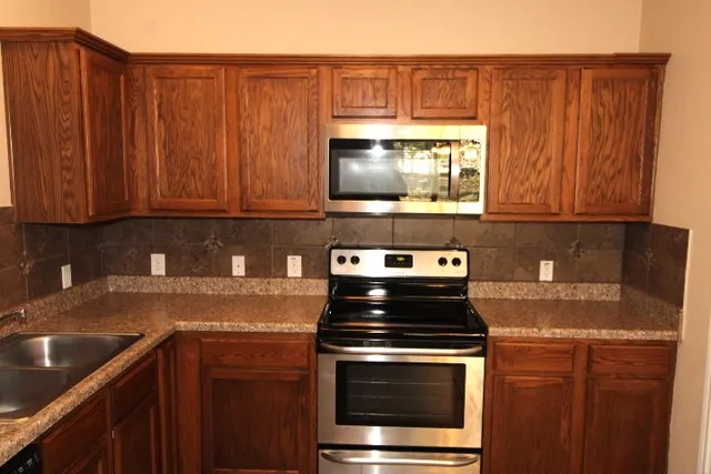 a kitchen with a stove and a microwave