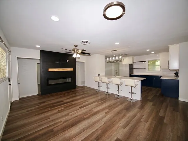 a view of kitchen with sink microwave and cabinets