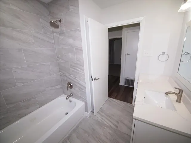 a bathroom with a bathtub and a sink