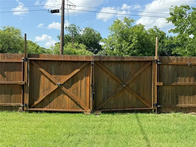 a view of a backyard with a garden and entertaining space