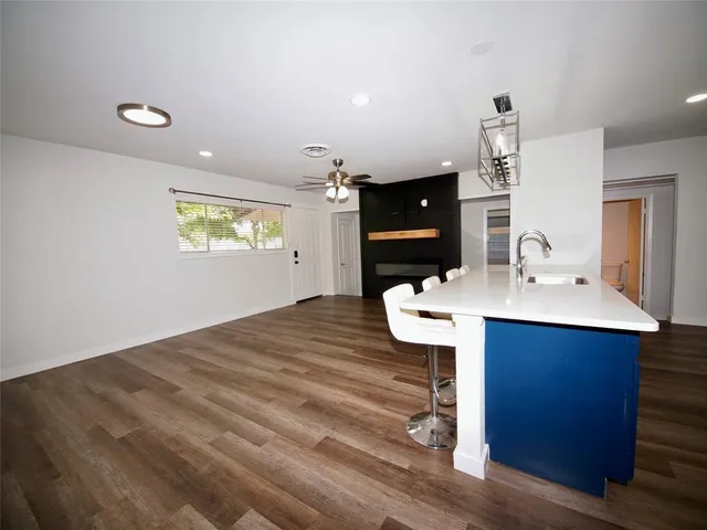 a kitchen with a sink cabinets and wooden floor