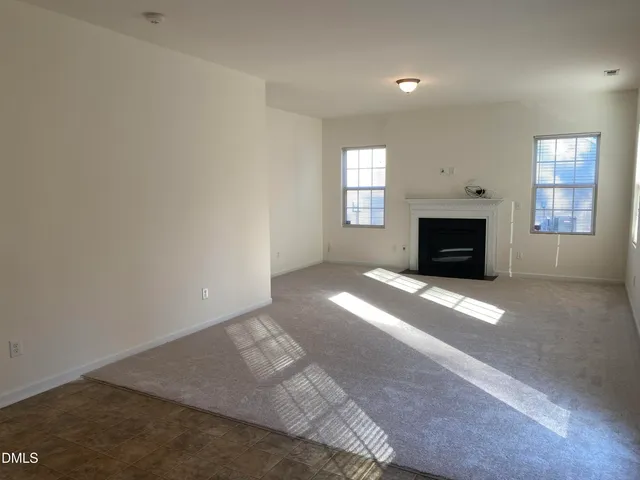 a view of empty room with a fireplace