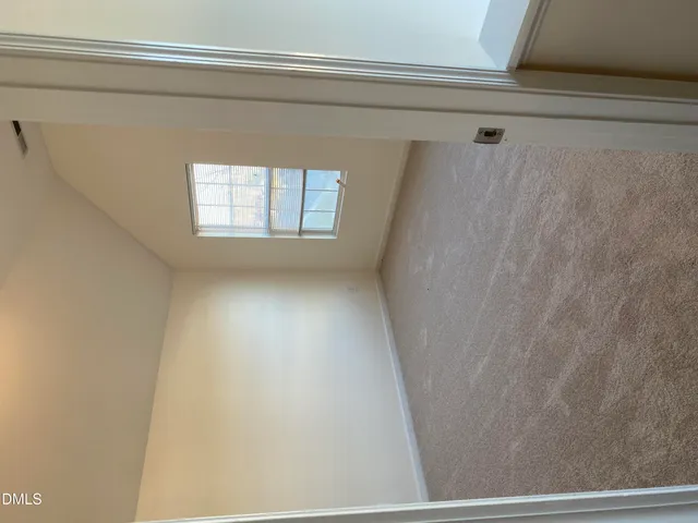 a view of a closet and a window