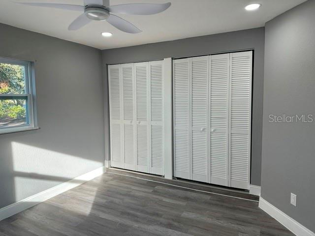 4520 North Hiawassee Road Orlando, FL 32818 - Photo 13 of 19 an empty room with wooden floor fan and windows