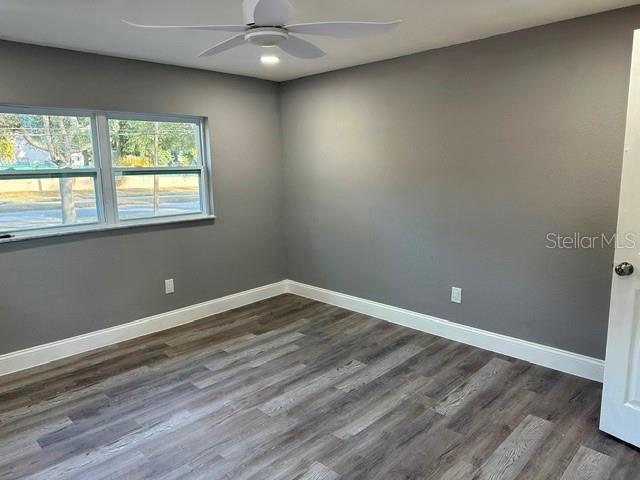 4520 North Hiawassee Road Orlando, FL 32818 - Photo 14 of 19 a view of an empty room with wooden floor and a window