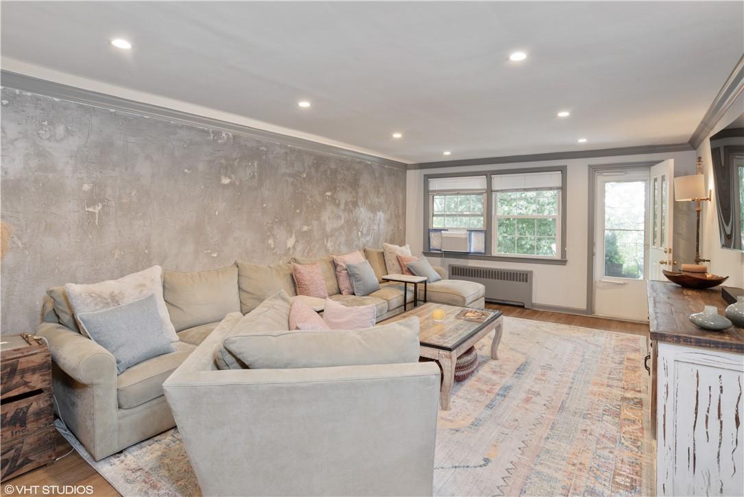 65 Rockledge Road, Unit 1H Bronxville, NY 10708 - Photo 1 of 1 a living room with furniture and a large window