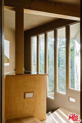 a view of an empty room with windows