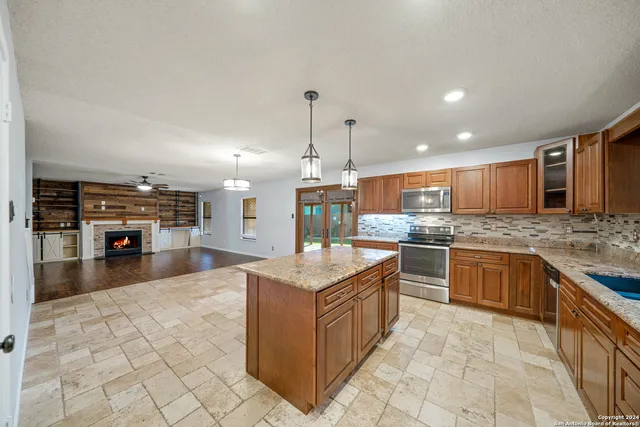 a kitchen with stainless steel appliances granite countertop a stove oven and a refrigerator