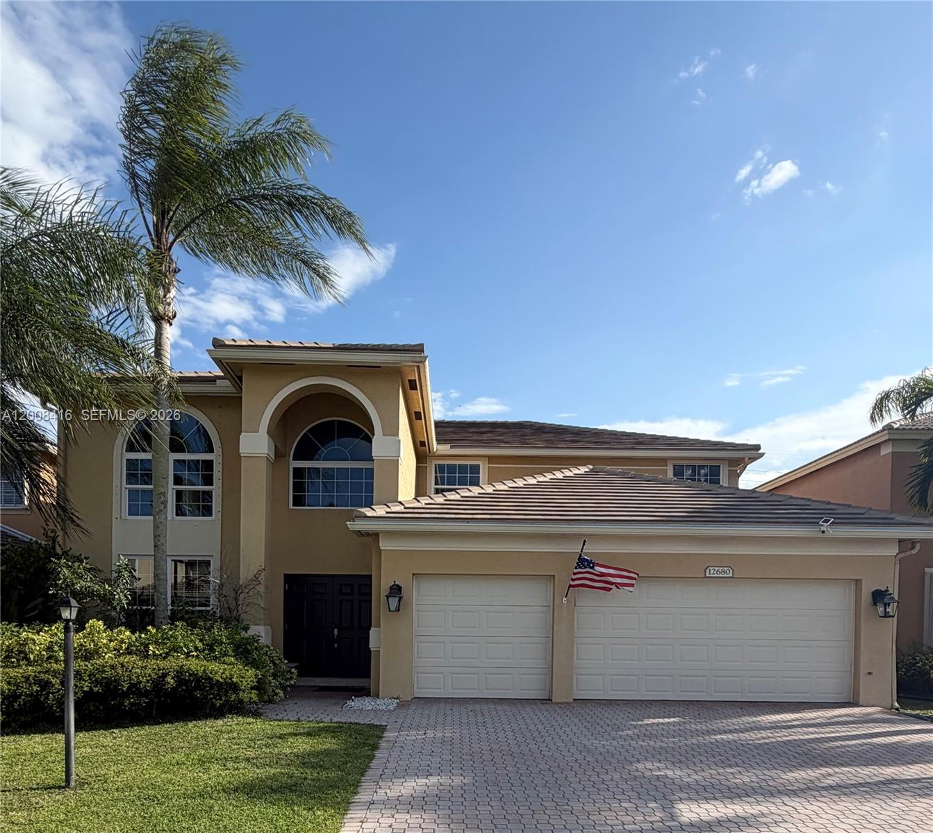 12680 Little Palm Lane Boca Raton, FL 33428 - Photo 1 of 13 a front view of a house with a garden