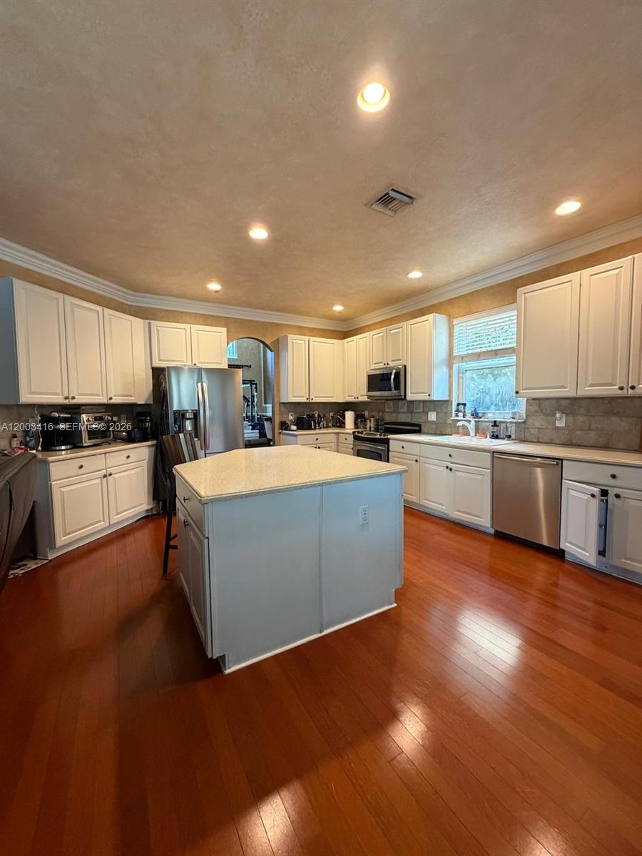 12680 Little Palm Lane Boca Raton, FL 33428 - Photo 3 of 13 a large kitchen with stainless steel appliances granite countertop a stove cabinets and wooden floor