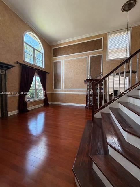 12680 Little Palm Lane Boca Raton, FL 33428 - Photo 6 of 13 a view of an empty room with wooden floor and windows
