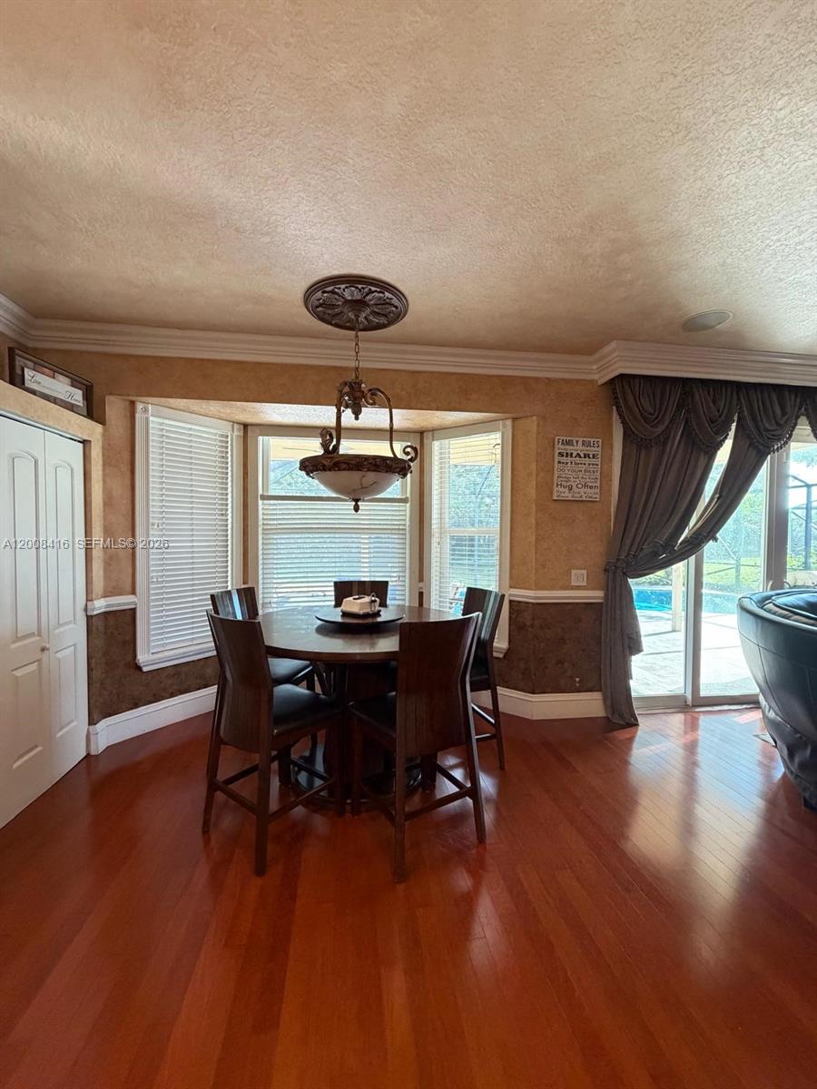 12680 Little Palm Lane Boca Raton, FL 33428 - Photo 7 of 13 a view of a dining room with furniture window and wooden floor