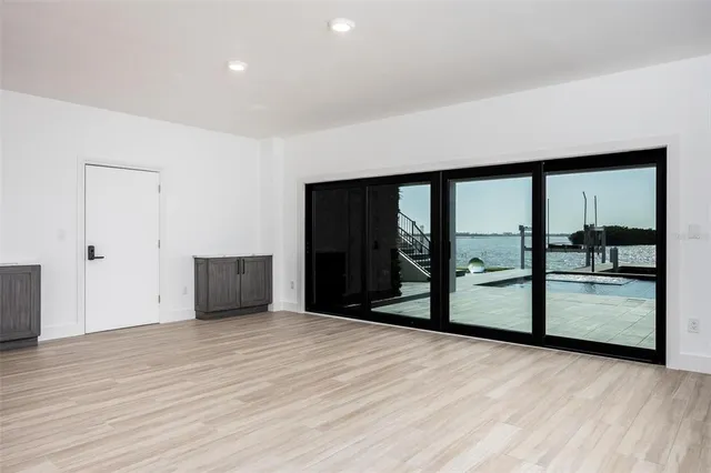 a view of ocean with boats and palm trees