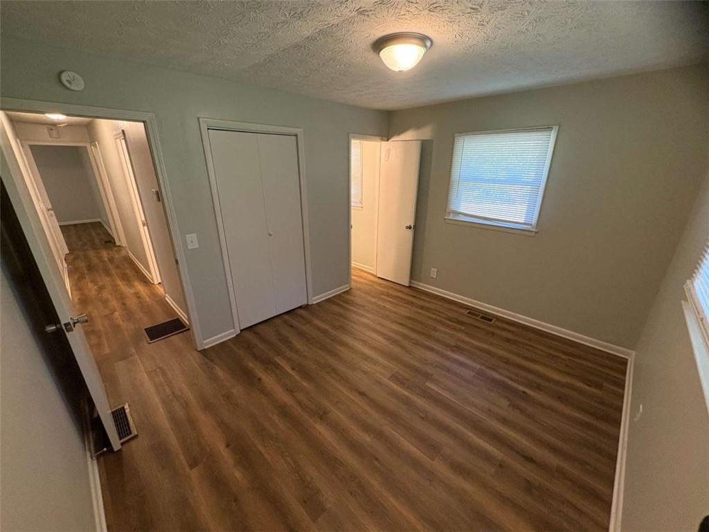 511 East Marable Street Monroe, GA 30656 - Photo 12 of 15 an empty room with wooden floor and a window