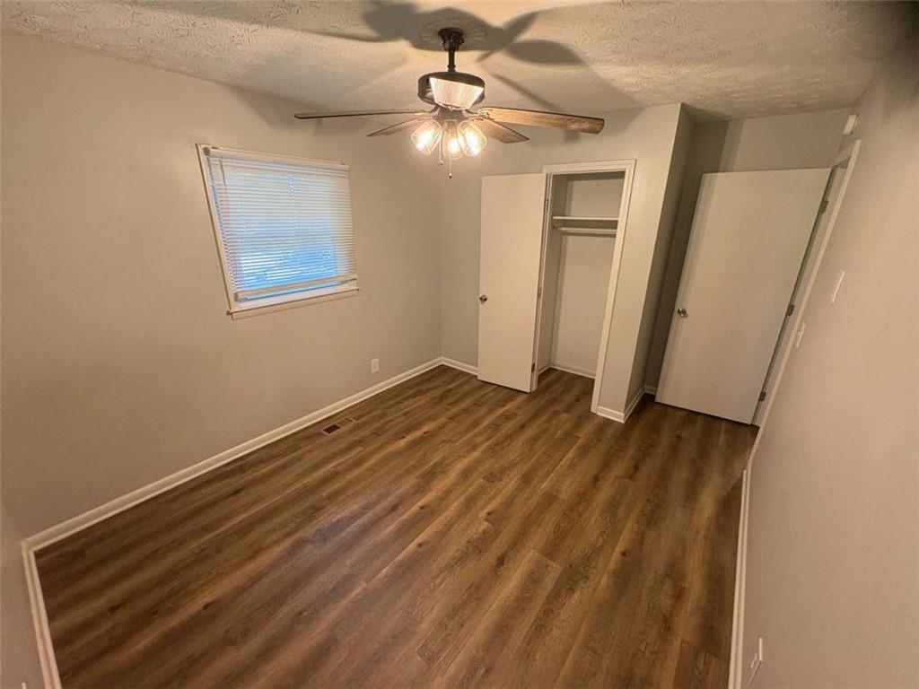 511 East Marable Street Monroe, GA 30656 - Photo 14 of 15 a view of an empty room with wooden floor and a ceiling fan