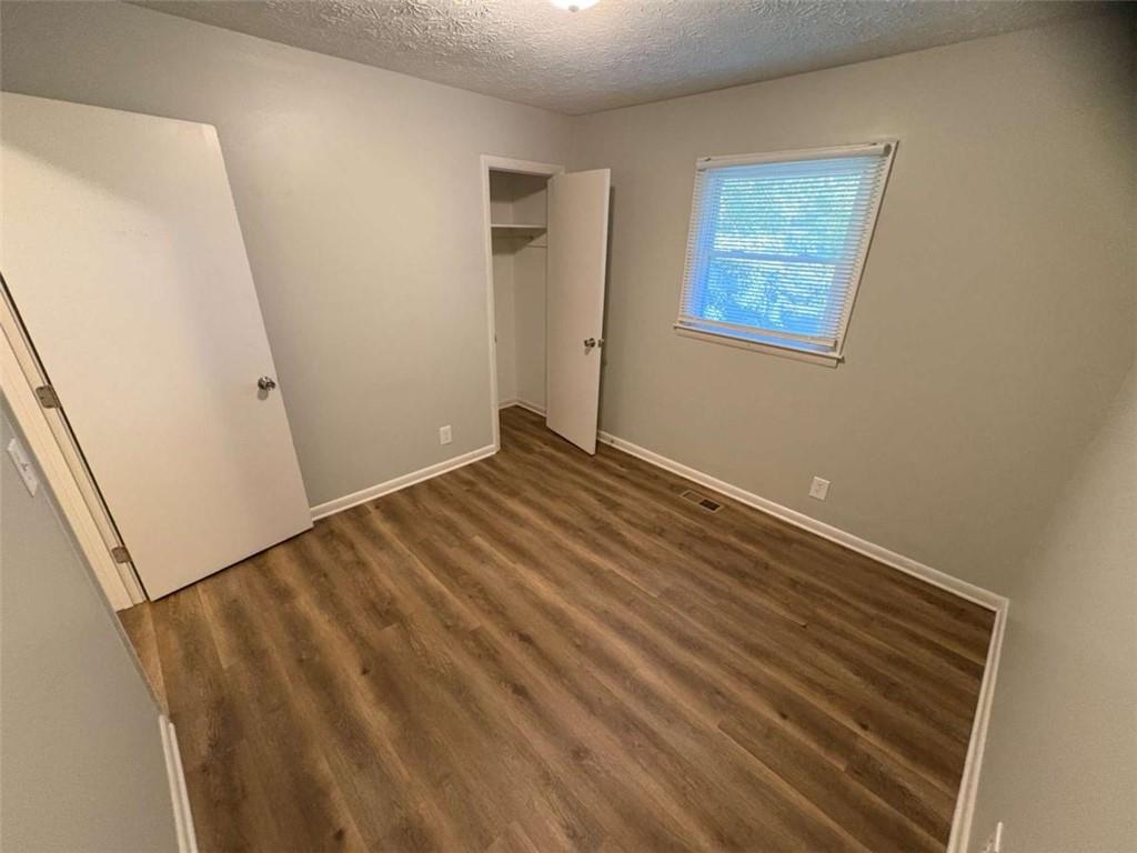 511 East Marable Street Monroe, GA 30656 - Photo 9 of 15 a view of a room with wooden floor and white walls