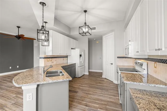 a kitchen with a sink and cabinets