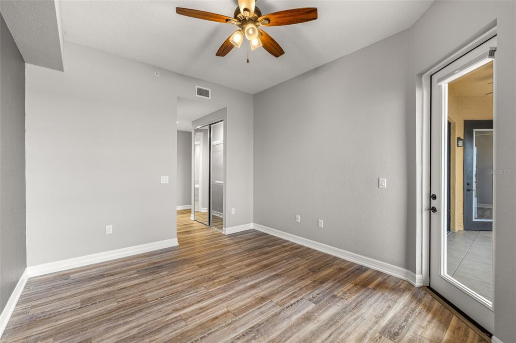 99 Vivante Boulevard, Unit 305/9935 Punta Gorda, FL 33950 - Photo 21 of 73 a view of an empty room with window and wooden floor