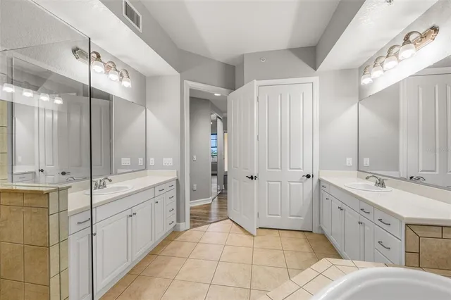 a view of a hallway with wooden floor and chandelier