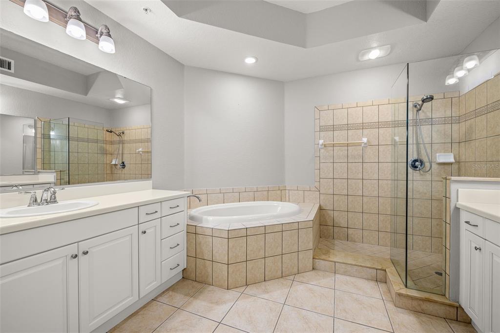 99 Vivante Boulevard, Unit 305/9935 Punta Gorda, FL 33950 - Photo 25 of 73 a bathroom with a double vanity sink a mirror and a shower