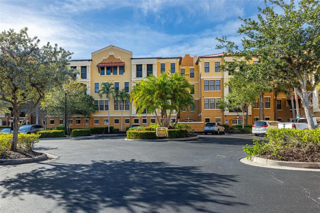 99 Vivante Boulevard, Unit 305/9935 Punta Gorda, FL 33950 - Photo 3 of 73 a view of a brick house with a lawn chairs and a fire pit