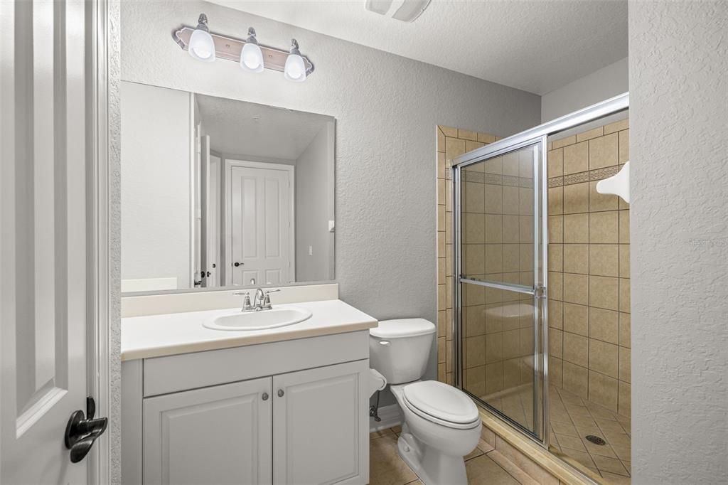 99 Vivante Boulevard, Unit 305/9935 Punta Gorda, FL 33950 - Photo 34 of 73 a bathroom with a toilet a sink a mirror and shower