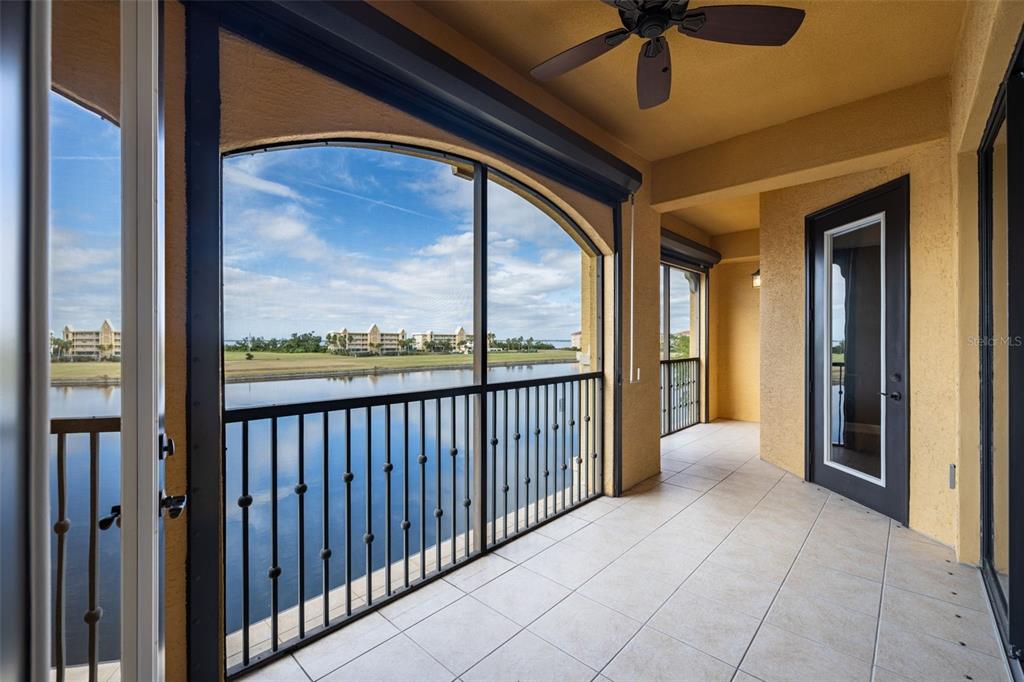 99 Vivante Boulevard, Unit 305/9935 Punta Gorda, FL 33950 - Photo 39 of 73 a view of a porch with a table and chairs