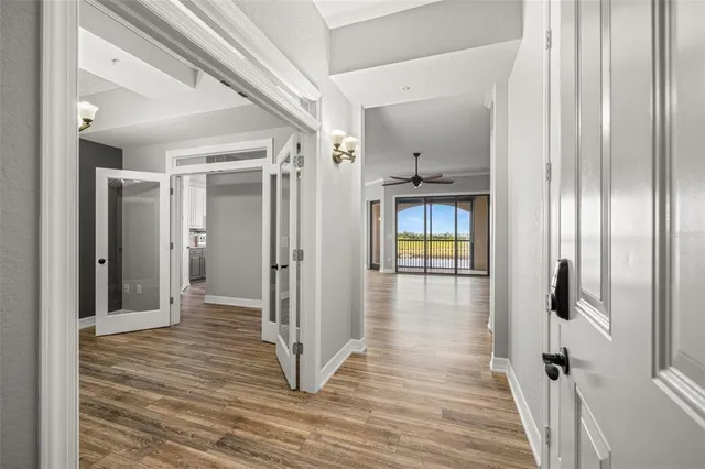 a view of a hallway with wooden floor