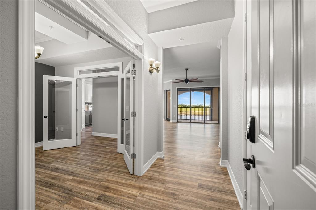 99 Vivante Boulevard, Unit 305/9935 Punta Gorda, FL 33950 - Photo 4 of 73 a view of a hallway with wooden floor and staircase