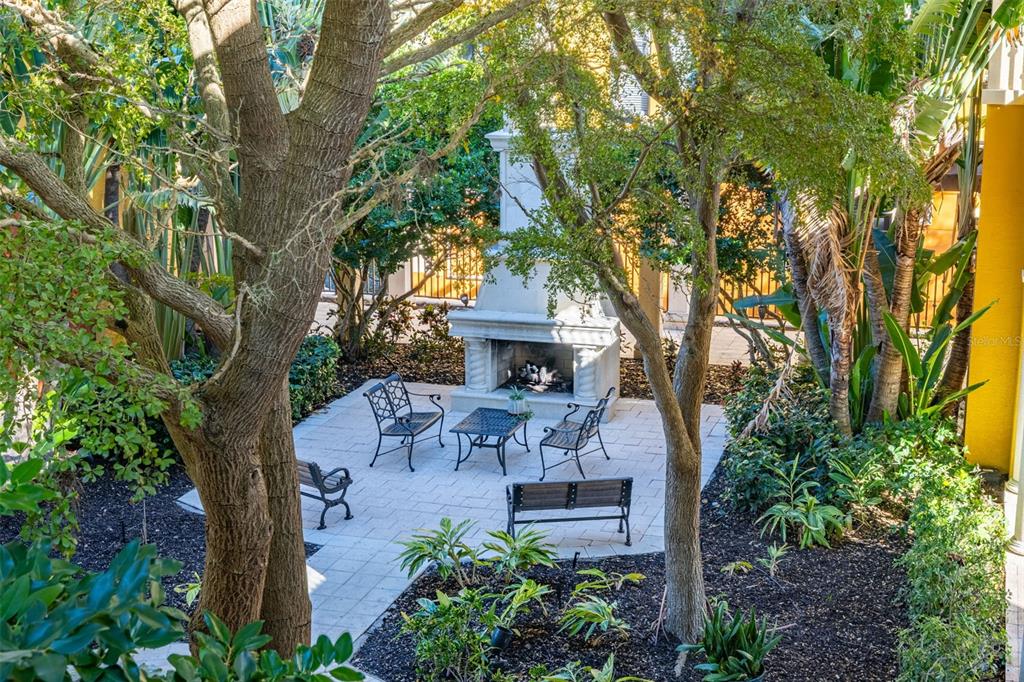 99 Vivante Boulevard, Unit 305/9935 Punta Gorda, FL 33950 - Photo 48 of 73 a view of a patio with table and chairs under an umbrella