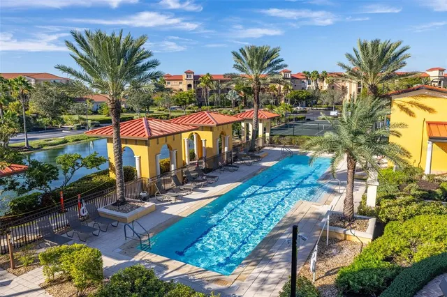 an aerial view of a house with a swimming pool patio and outdoor seating