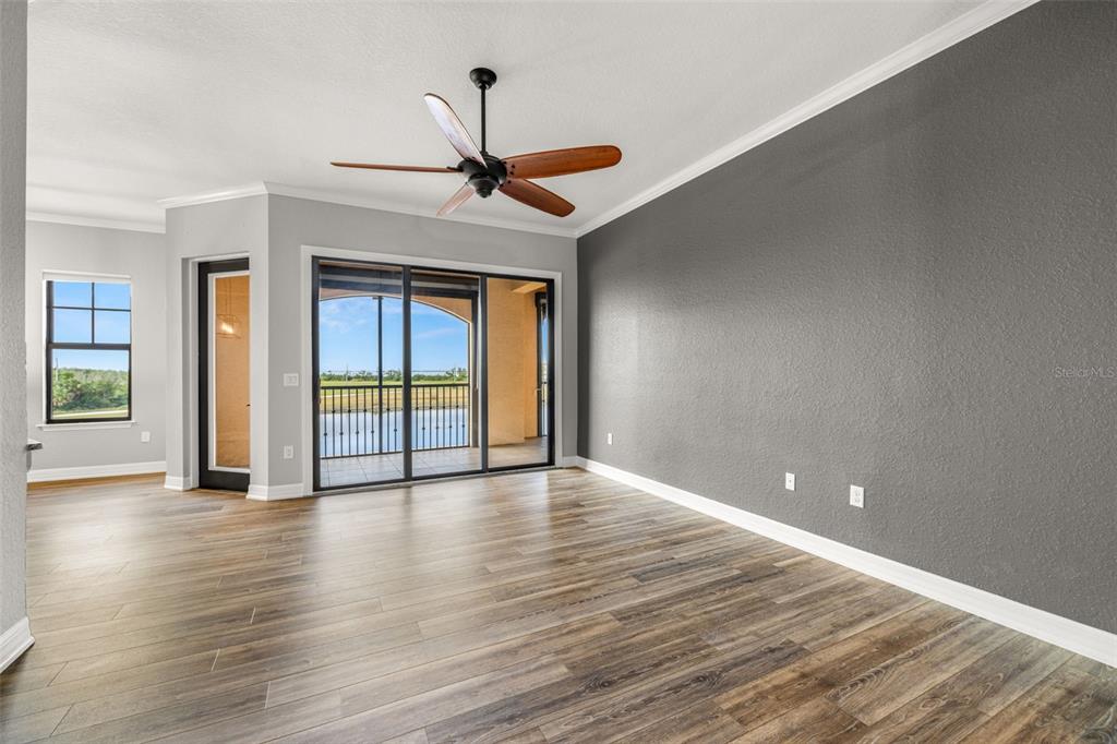 99 Vivante Boulevard, Unit 305/9935 Punta Gorda, FL 33950 - Photo 6 of 73 a view of an empty room with window and wooden floor
