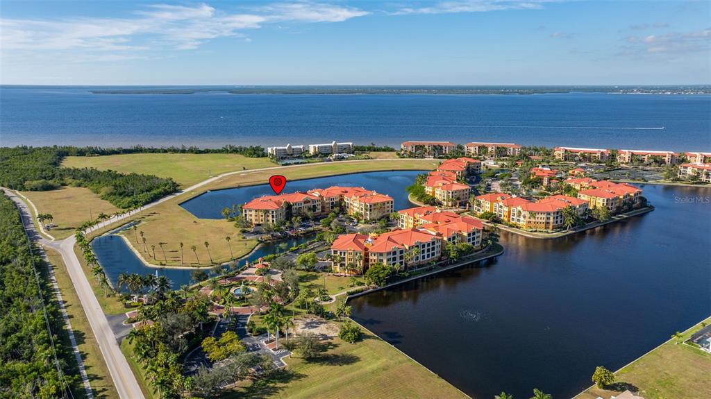 99 Vivante Boulevard, Unit 305/9935 Punta Gorda, FL 33950 - Photo 70 of 73 an aerial view of a house with a garden and lake view