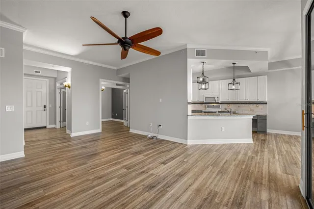 a view of a kitchen with a sink and dishwasher with wooden floor
