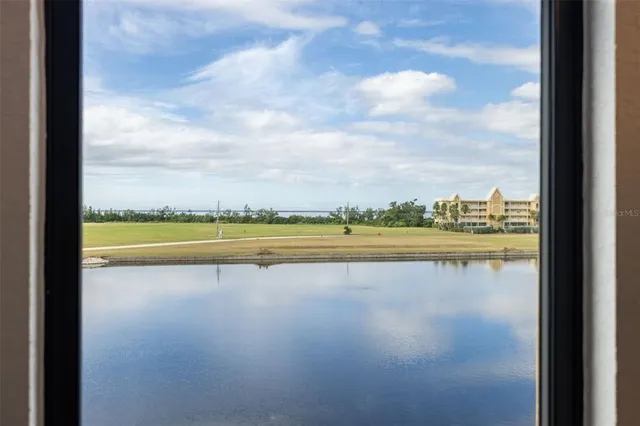 a kitchen with stainless steel appliances granite countertop a sink dishwasher and a refrigerator with wooden floor