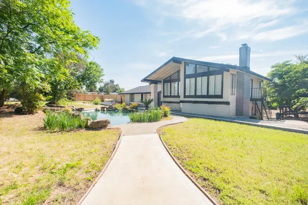 a swimming pool with outdoor seating and yard