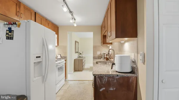 a kitchen with refrigerator and cabinets