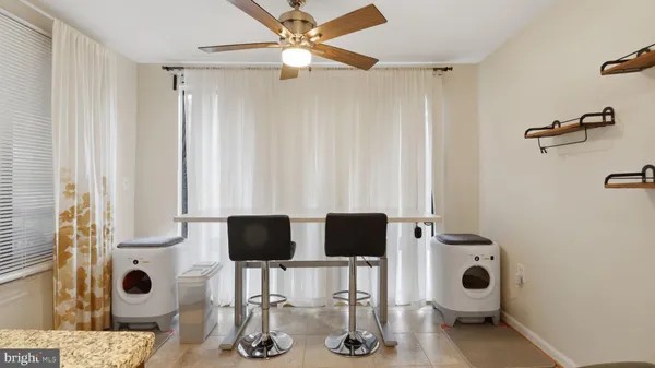 a view of kitchen with furniture and windows