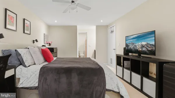 a bedroom with a bed and a flat screen tv