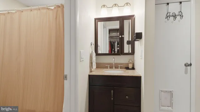 a bathroom with a double vanity sink and a mirror