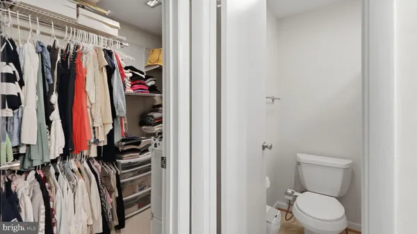 a view of walk in closet with clothes